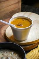 soup in cup on table wood photo