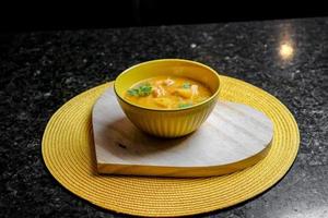 Bowl of soup in a wooden heart photo