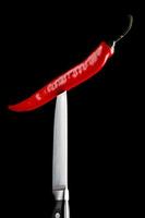 Red chili pepper and knife photo