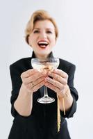 mature stylish elegant woman in tuxedo with glass of sparkling wine. Party, celebration, anti age concept photo