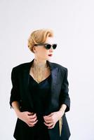 fashionable mature woman in tuxedo and sunglasses. Make up, fashion, anti aging concept photo