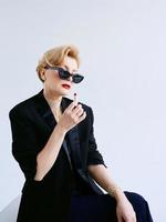 fashionable mature woman in tuxedo with lipstick. Make up, fashion, anti aging concept