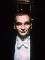 portrait of young man in bow tie and tail-coat underwater on the black background photo