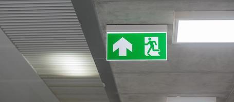 Fire Emergency exit sign on the wall inside building at subway train station. Safety concept photo