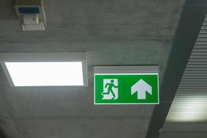 Fire Emergency exit sign on the wall inside building at subway train station. Safety concept photo