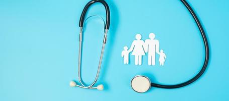 Happy Family day. Stethoscope and paper shape cutout with Father, Mother, and Children. international day of families, Health, wellness, Life and Insurance concepts. photo