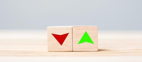 wood cube block with UP and Down arrow symbol icon on table. Interest rate, stocks, financial, ranking, mortgage rates and Cut loss concept photo