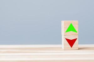 wood cube block with UP and Down arrow symbol icon on table. Interest rate, stocks, financial, ranking, mortgage rates and Cut loss concept photo