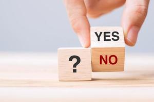 Hand change Yes or No block. Answer, question and decision concept photo