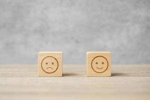 emotion face symbol on wooden blocks. mood, Service rating, ranking, customer review, satisfaction, evaluation and feedback concept photo