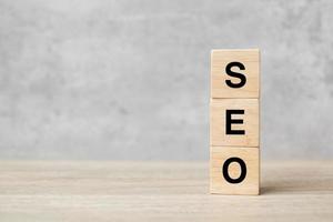 SEO Search Engine Optimization text wooden cube blocks on table background. Idea, Strategy, advertising, marketing, Keyword and Content concept photo