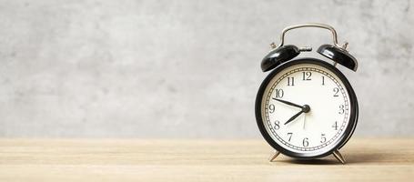 Vintage alarm clock on wooden table background and copy space for text. Activity, daily routine, morning, workout and Work life balance concept photo