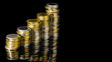 Macro shot detail of golden and silver color coin stacks on dark background with copy space for text. Business and finance growth, saving money, investment and interest concept. photo