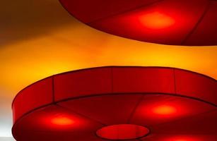 Interior ceiling red lights on dark background at night. Interior lighting concept. Red lights on ceiling wall. Interior architecture. photo