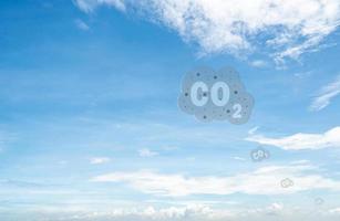 CO2 symbol on blue sky and white clouds. CO2 emissions. Greenhouse gas. Carbon dioxide gas global air climate pollution. Environment issue. Background for carbon capture and storage technology. photo