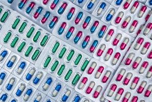Full frame of colorful capsule pills in blister pack arranged with beautiful pattern. Pharmaceutical packaging. Medicine for infections disease. Antibiotic drug use with reasonable. Drug resistance. photo