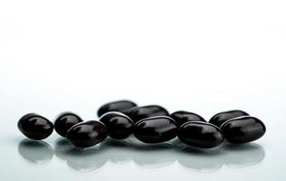 píldoras de tabletas negras sobre un fondo blanco. tabletas de vitaminas y minerales para mujeres embarazadas. Pastillas para el tratamiento de la anemia por fumarato ferroso. foto