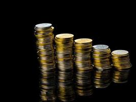 Macro shot detail of golden and silver color coin stacks on dark background with copy space for text. Business and finance growth, saving money, investment and interest concept. photo