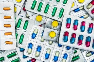 Top view of colorful tablets and capsules pills in blister packs. Global health care and drug use with reasonable concept photo