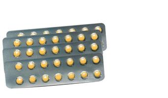 Rabeprazole Small round light yellow enteric-coated tablet pills in blister pack isolated on white background with copy space. Medicine for treatment gastric ulcer stomach ulcer or GERD. photo