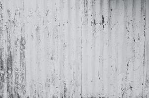 Galvanized sheet painted with white color. Empty white wall texture background. Peeling paint on white wall. Distorted striped gray galvanized sheet. Empty white and gray background for minimal life. photo