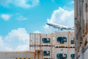 Cargo airplane flying above logistic container. Air logistic. Reefer for frozen food. Refrigerated container for export and import logistics. Freight transport. Aviation business. Merchandise export. photo