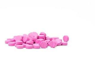 Pile of warfarin pink tablet pills on white background. Warfarin for treatment deep vein thrombosis. Anticoagulant medicine. Pharmacy drug store product. Pharmaceutical industry. Anticoagulation. photo