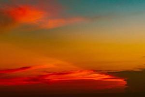 Dramatic red and orange sky and clouds abstract background. Red-orange clouds on sunset sky. Warm weather background. Art picture of sky at dusk. Sunset abstract background. Dusk and dawn concept photo