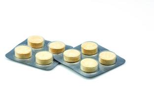 Anthelmintic tablets pills in blister packs on white background with copy space. Set of four tablets pills  niclosamide and phenolphthalein for treatment tapeworm. Chewable tablet pills. photo