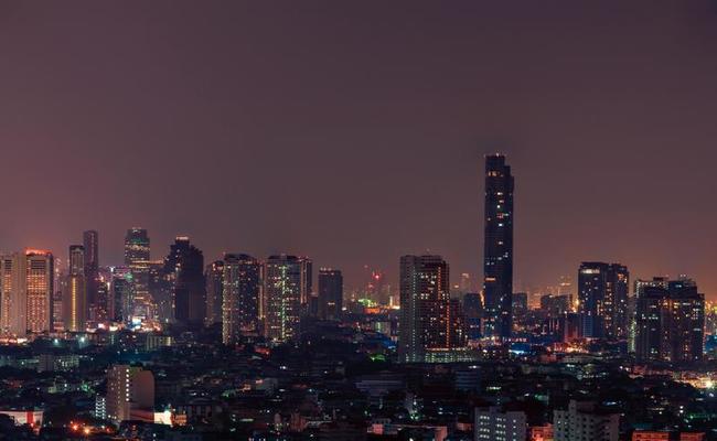 Cityscape of modern building in the night. Modern architecture office building. Skyscraper with beautiful evening sky. Business and financial center building. Apartment in the city with night light.