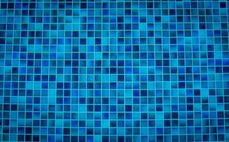 Blue tile pattern of swimming pool tiles. Pool tiles texture background. Clean water with swimming pool mosaic tiles floor. Modern pattern of tiny square pool mosaic floor of bathroom or shower room. photo