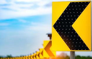 Traffic sign with solar cell panel power on blue sky and clouds background. Electric pole with solar energy. Green energy concept. Renewal energy. Alternative electricity source. Sustainable resources photo