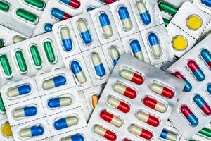 Top view of colorful tablets and capsules pills in blister packs. Global health care and drug use with reasonable concept photo