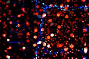 Christmas and happy new year decoration light. Red, blue, orange color bokeh background with beautiful pattern. Defocused Xmas light in the night of party. Christmas holiday bokeh background. photo