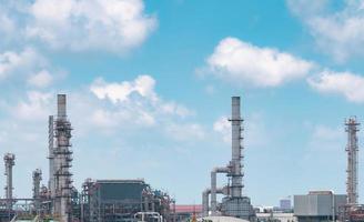 Oil refinery or petroleum refinery plant with blue sky background. Power and energy industry. Oil and gas production plant. Petrochemical industry. Natural gas storage tank. Petroleum business. photo