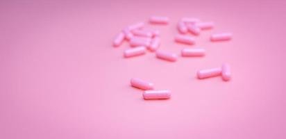 Pink capsules pill on pink background. Vitamins and supplements. Online pharmacy. Pharmacy store banner. Pharmaceutical industry. Woman's health insurance concept. Pills for love and happy life. photo