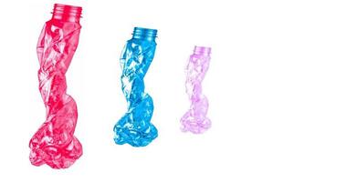 Waste of red, blue, and pink plastic bottles. Twisted empty bottle. Plastic bottle waste for recycle in recycling business. Plastic waste management. Reduce and reuse plastic. PET bottle for recycle.