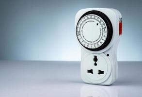 Plug-in timer mechanical 24 hour. Indoor home tools. Plug-in timer socket set isolated on white background. Mechanical outlet timer. Home security supply. Smart home tools. Mechanical timer switch. photo