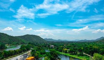 Beautiful nature landscape of mountain range with sunrise sky and clouds. City in mountain valley in Thailand. Scenery of mountain layer with morning sunrise. Tropical forest. Nature background. photo