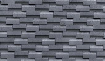 Gray brick wall with simple pattern. Gray wall texture abstract background. Modern design of brick wall background. Simple abstract wallpaper. Concrete surface texture. Exterior architecture design. photo