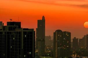 Cityscape with beautiful morning sunrise sky. Air pollution in Bangkok, Thailand. Smog and fine dust of pm2.5 covered the city. Cityscape with polluted air. Dirty environment. Urban toxic dust. photo