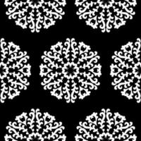 White round lace patterns on a black background. Beautiful seamless background with floral mandalas. Black and white. Vector vintage round ornament.