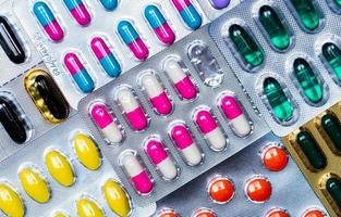 Colorful of tablets and capsules pill in blister packaging arranged with beautiful pattern with flare light. Pharmaceutical industry concept. Pharmacy drugstore. Antibiotic drug resistance. Defective. photo