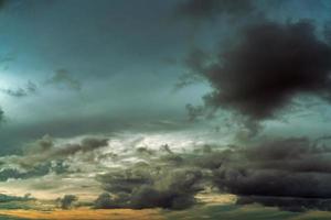 Sunset sky and gray and golden clouds. Gray sky and fluffy clouds. Thunder and storm sky. Sad and moody sky. Dead abstract background. Cloudscape. Peaceful and tranquil background. Beauty in nature. photo