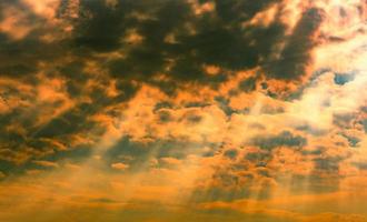 God light. Dramatic dark cloudy sky with sun beam. Yellow sun rays through dark and white clouds. God light from heaven for hope and faithful concept. Believe in god. Beautiful sunlight sky background photo