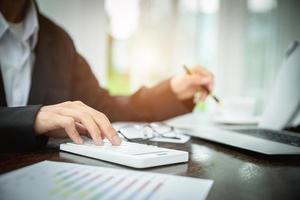 Young Businessman Analyzing Graph On Computer At Workplace photo