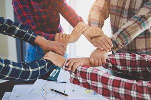 A diverse group of people connects their hands as a supportive sign expressing a sense of teamwork. Unity and togetherness. business teamwork. photo