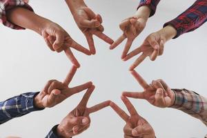 A diverse group of people connects their hands as a supportive sign expressing a sense of teamwork. Unity and togetherness. photo