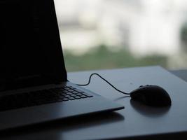 notebook with mouse on the table photo