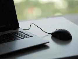 notebook with mouse on the table photo